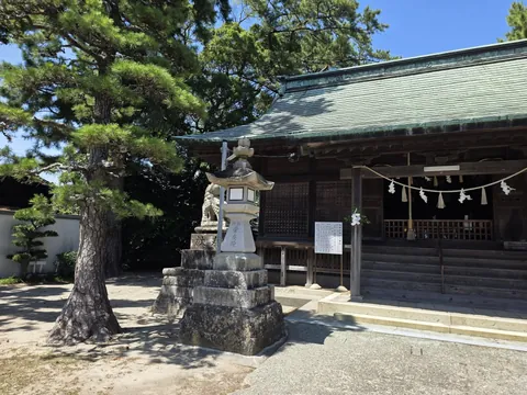 松の木と石灯籠を前景にした貴船神社の社殿。
